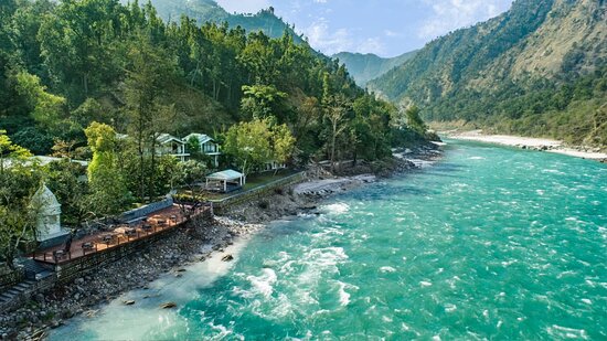 Riverside resort near Jim Corbett National Park with turquoise river mountain views and peaceful nature stay Uttarakhand